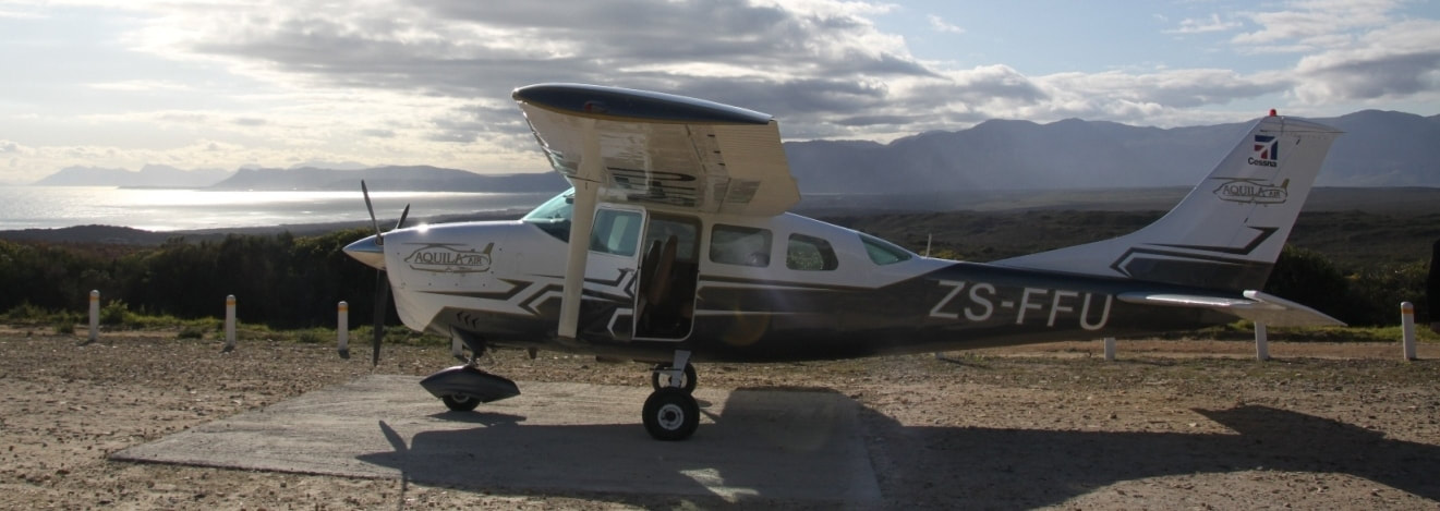 Cessna 6 seater plane flights over the ocean and coastal scenery, near Hermanus